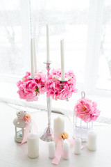 Vase of pink peony ,candle and sweets