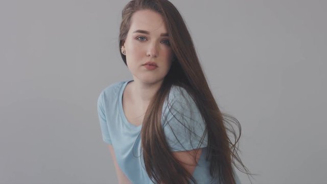 young baby face model in studio. Long straight hair blue eyed model in casual look