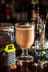Cocoa poured into a glass Cup with spices and chocolate.