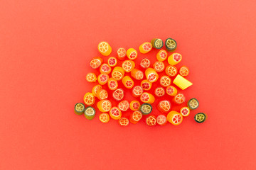 Assortment of colorful sweet handmade candy pieces arranged on red paper