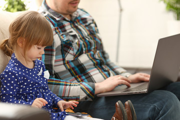 Cute little girl on couch with dad use cellphone