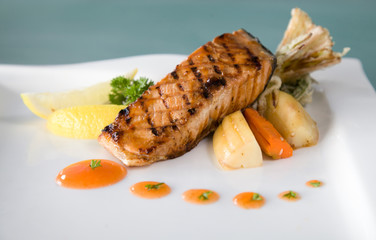 delicious grilled tuna fish portion n plate ready to serve at restaurant on white background