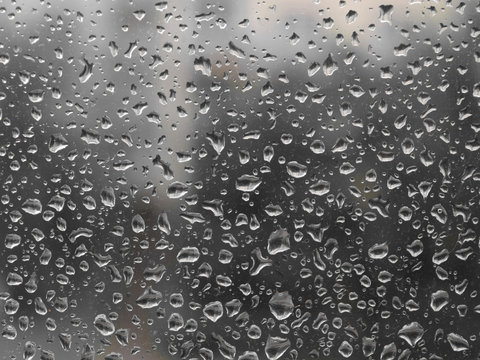 Grey rainy day. Drops of rain on the glass. Background
