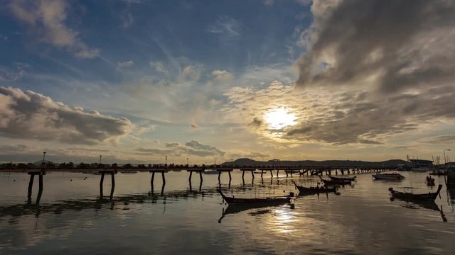 4-K time lapse of longtail fishing boats in aochalong harbor phuket thailand