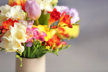 Beautiful bouquet of freesia flowers on blurred background
