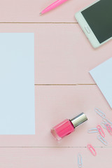 Feminine desk workspace with succulent, glasses, cup for coffee and paper for copyspace