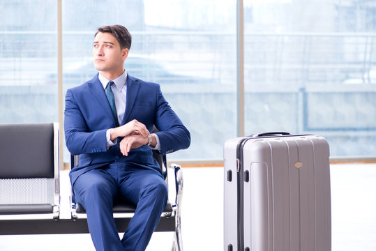 Businessman waiting at the airport for his plane in business cla