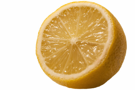 Fresh juicy lemon in section cut bright saturated yellow fruit close-up white isolated background