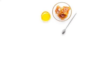 Apiary products. Honey in bowl and honeycomb on white background top view copy space