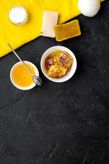 Aromatic theraphy and delicate skin care. Spa set based on honey on black background top view space for text