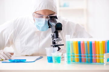 Young chemist student working in lab on chemicals