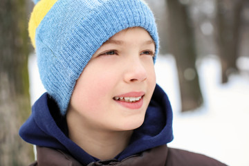 Cute boy on frosty day outdoors. Winter vacation