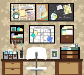 Working space with a desk, chair, planning boards and other items.