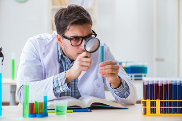 Young chemist student working in lab on chemicals