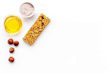 Energy protein snacks with hazelnuts on white background top view copy space