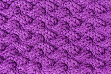 knitted fabric background in purple in cable pattern