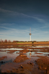 Obraz premium View of a Radio mast and tower with landscape field view. Fernmeldeturm Broitzem in Braunschweig, Germany
