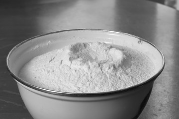 White enamel bowl with wheat flour