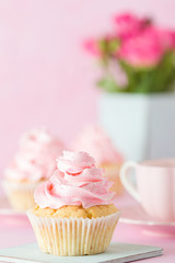 Pink pastel vertical banner with decorated cupcakes, cup of coffe with milk and bouquet of pink roses.