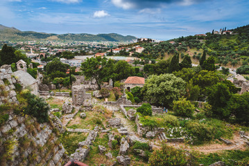 Fototapeta na wymiar Montenegro landscape with cloudy mountains and ancient stone ruines of Old Bar town. Stari Bar - ruined medieval city on Adriatic coast, Unesco World Heritage Site.