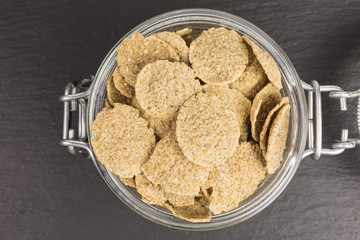 triticum spelta - spelt flakes for a healthy breakfast in a glass jar