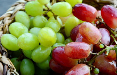 Green and Purple grapes in basket
