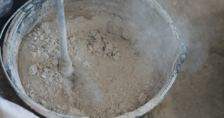 mixing concrete plaster with electric mixer