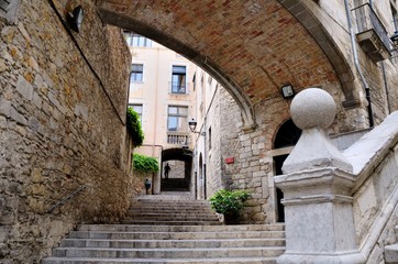 The old city of Girona. Pujada de Sant Domenec stairs and Arch of the Agullana Palace, Catalonia, Spain.