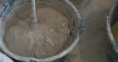 mixing concrete plaster with electric mixer