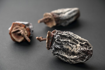 Dried persimmons on a dark background