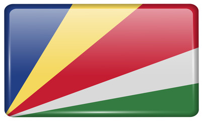 Flags SEYCHELLES in the form of a magnet on refrigerator with reflections light.