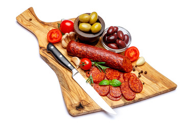 Dried organic salami sausage or chorizo on wooden cutting board