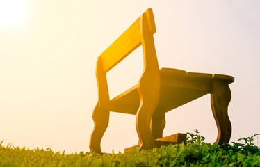 the Old Long Chairs Chair on green grass with sunlight in morning period