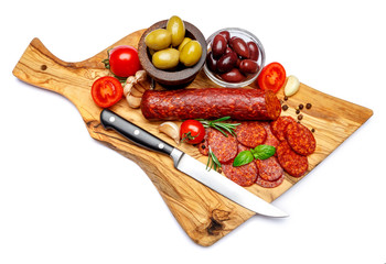 Dried organic salami sausage or chorizo on wooden cutting board