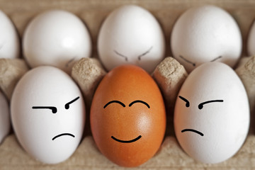 eggs in a cardboard box in the form of funny faces