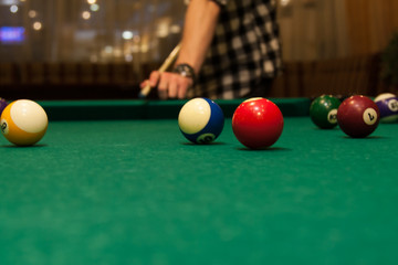 A player in Russian billiards beats a cue ball