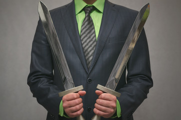 Businessman holds in hand a toy sword weapon. Life or finance insurance agent. Money deposite...