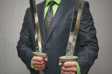 Businessman holds in hand a toy sword weapon. Life or finance insurance agent. Money deposite...