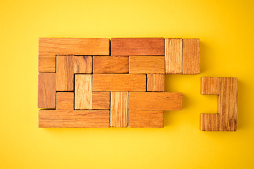 last wooden brick is ready to complete the construction