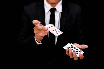 Gambling Concepts. Businessmen are gambling in the casino. Betting is a gamble for investors. Businessmen are playing card games on a black background.