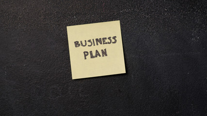Sticky note with Business Plan on the blackboard