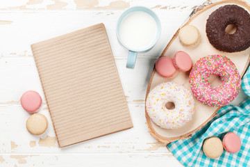 Milk and donuts on wooden table