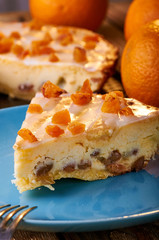 One of the options for a delicious dessert is cheesecake. Polish Cracow cheese cake. Appetizing syrnik with dried fruits and oranges. A treat for children and adults in warm orange tones.