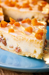One of the options for a delicious dessert is cheesecake. Polish Cracow cheese cake. Appetizing syrnik with dried fruits and oranges. A treat for children and adults in warm orange tones.