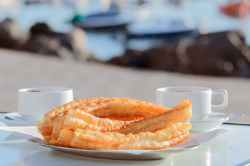 Typical Spanish snack churros are deep-fried pastries  and served with hot chocolate everywhere in Spain. Churros con chocolate is a classic Spanish breakfast