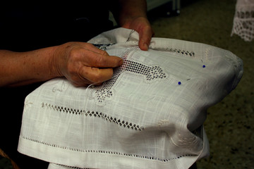A close up view of an old woman's hands, embroidering Lefkara Lace or 'Lefkaritika' a traditional handmade lace, in Pano Lefkara, Cyprus