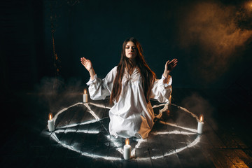 Witch in pentagram circle, evocation of spirits