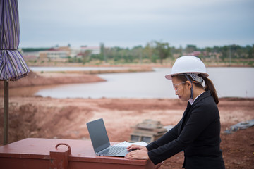 Engineer woman working at site of bridge under construction