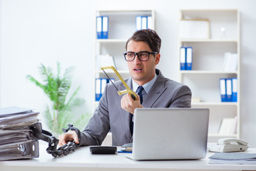 Busy employee chained to his office desk