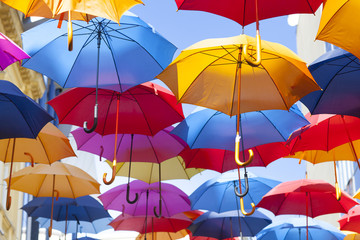 Colorful umbrellas hanging in the air